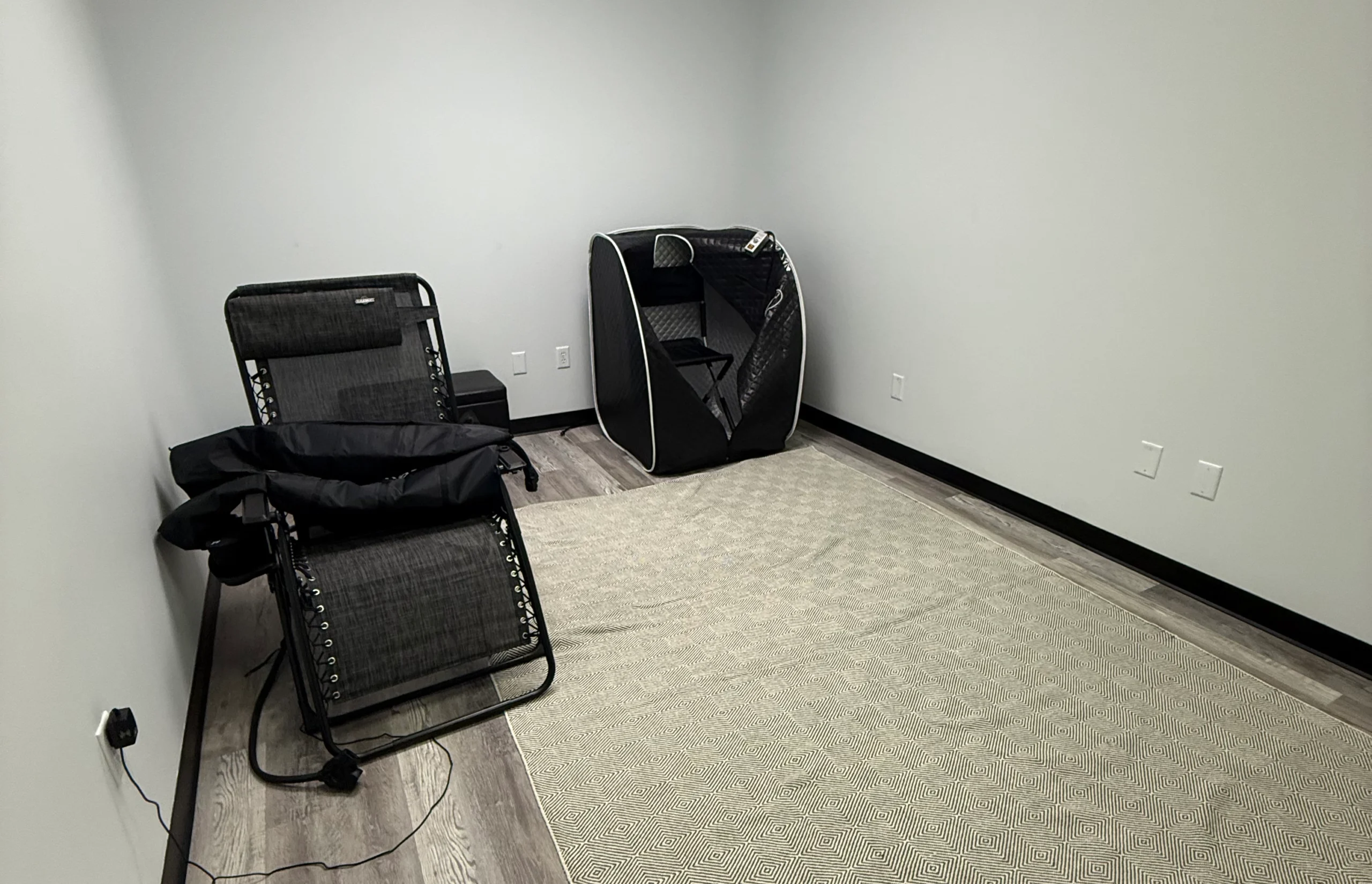 Recovery (1) Wide Image of an a 1 person infrared dry sauna and Normatec Compression boots inside Perform Fitness located in St. Louis Missouri.